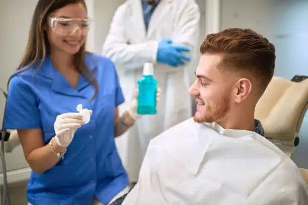 Dentist recommending mouthwash for bleeding gums and periodontal care