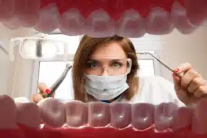 Dentist checking gums for signs of gum disease during a dental exam