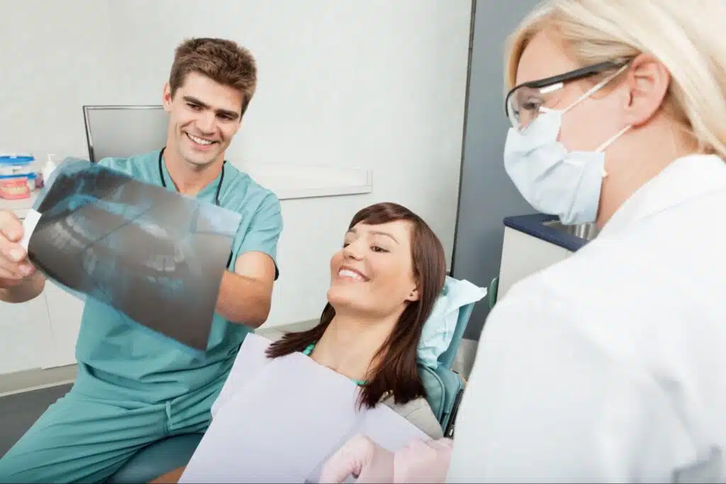 Dentist reviewing dental X-rays with patient