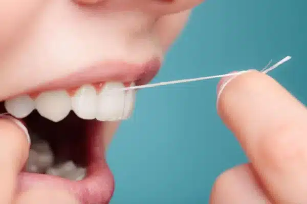 Flossing to help remove plaque and support early gum disease treatment