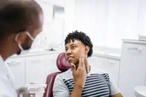 Patient learning the signs of gum disease during a preventive dental visit