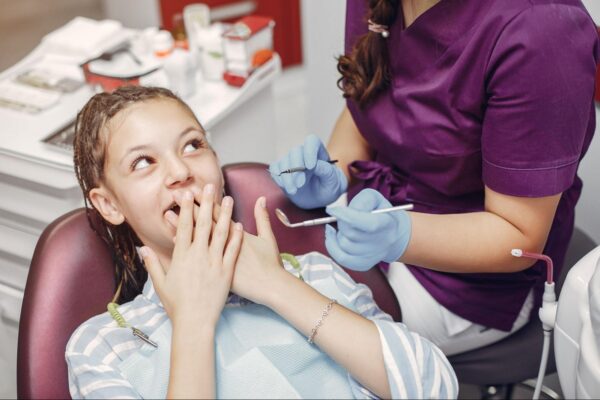 Child showing signs of dental anxiety before a dental visit